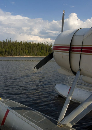 float plane that is dock on a lake in Quebec