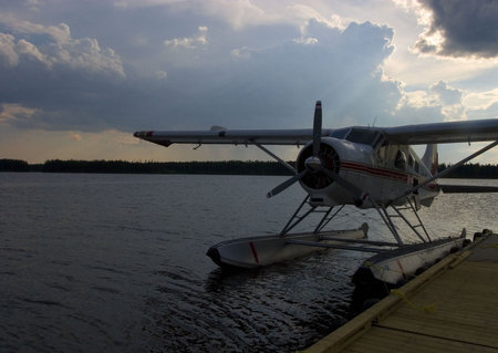 float plane tied up in Quebec at sunsetの写真素材