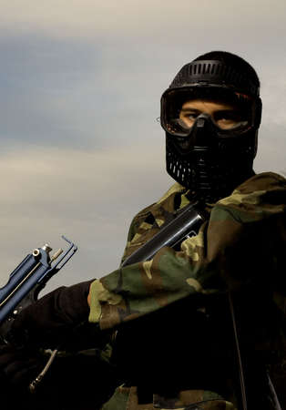 youngster that is ready for a game of paint ballの写真素材