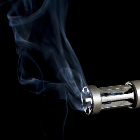 smoke rising from a flash hider on an assault weapon
