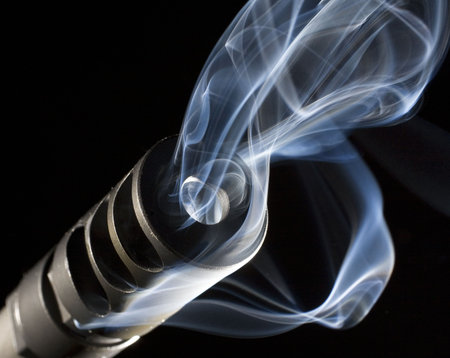 smoke pouring from the barrel of a precision bolt rifle