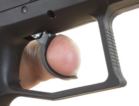 finger on the trigger of a gun isolated on a white background