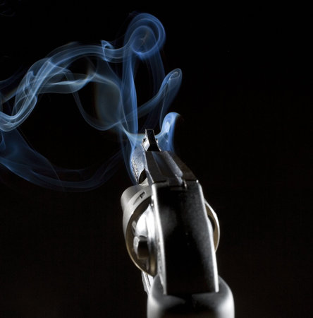 handgun that is a revolver that is pouring out smoke