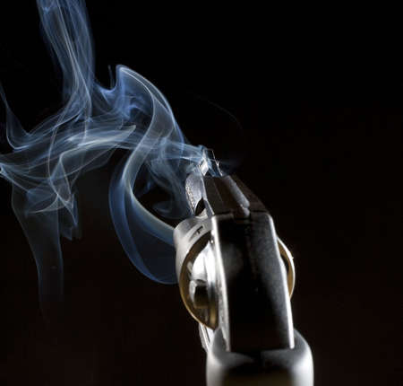 Looking down the sights of a gun in the darkの写真素材