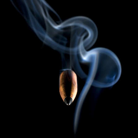 Bullet and smoke that appeared to have changed their trajectoryの写真素材