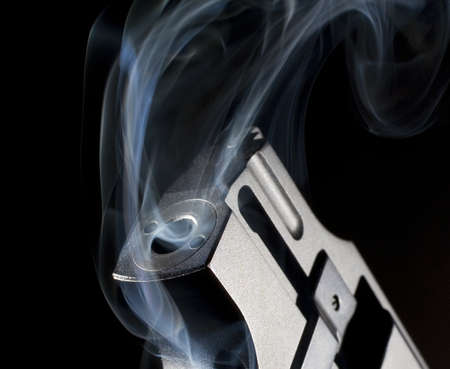 Revolver that is rising and belching smoke from withinの写真素材