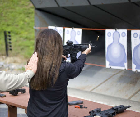 Brass being ejected out of a submachine gun during firingの写真素材