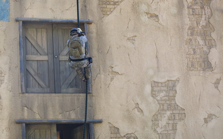 solidier with his gear fast roping down a buildingの写真素材