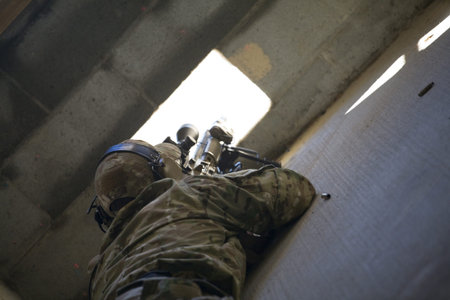 Sniper preparing to take a shot through a single window