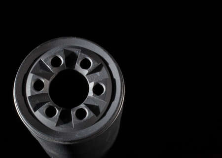 Front side of a suppressor with a dark backgroundの写真素材