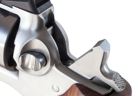 Hammer back on a revolver ready to shoot on white
