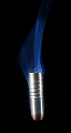 Bullet with bands coming down with smoke behindの写真素材