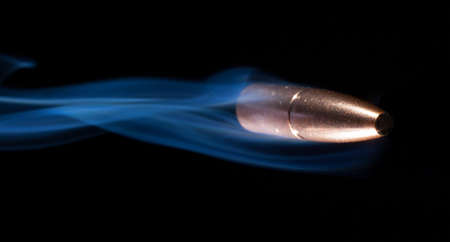 Copper jacketed bullet passing by the right of the cameraの写真素材