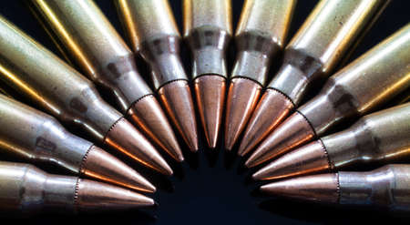 Rifle ammunition with bullets that have steel inside on a black backgroundの写真素材
