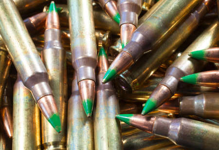 Ammunition with bullets with a green tip in a big pileの写真素材