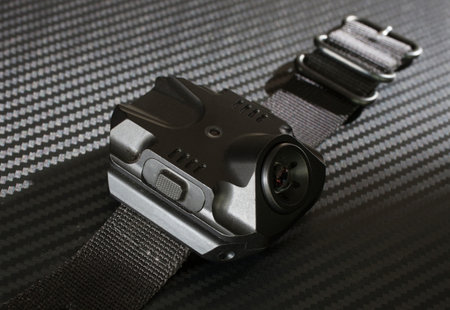 Flashlight with a metal housing that is worn on the wrist