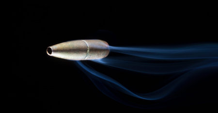 Bullet with copper plating that looks like it is flying with smoke behind