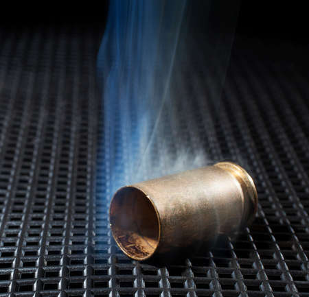 Handgun brass that has been shot with smoke all aroundの写真素材