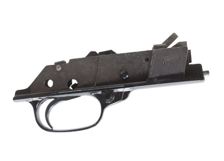 Trigger group and mechanism from a rifle seen from the side on white