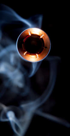 Copper plated hollow point bullet and smoke coming at the cameraの写真素材