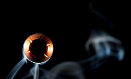 Hollow point bullet with smoke that looks like it is coming closeの写真素材