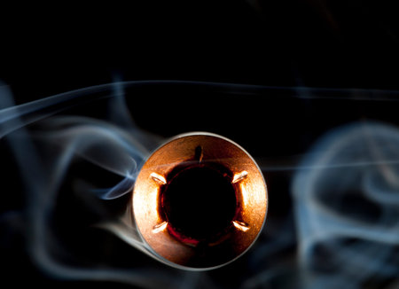 Copper plated hollow point bullet in the middle of smoke