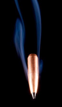 Polymer tipped bullet with copper and smoke that are coming at the viewerの写真素材