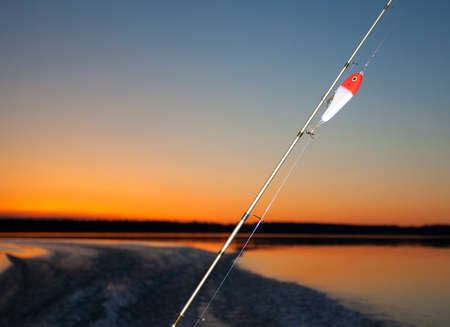 Twilight fishing rod and lure on a lake in Saskatchewan Canadaの写真素材