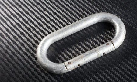 Old aluminum carabiner that has scratches from years of use