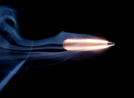Copper plated bullet with a polymer tip speeding with smokeの写真素材