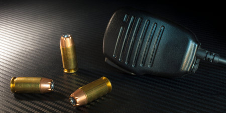 Police microphone with three hollow point handgun cartridges