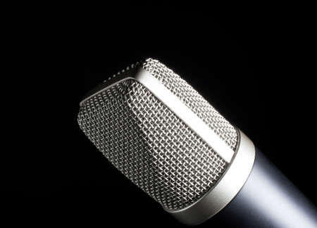 Metal mesh covered microphone on a black backgroundの写真素材
