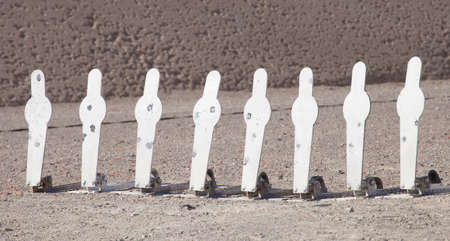 Steel targets that fall down when hit by a shot from a pistolの写真素材