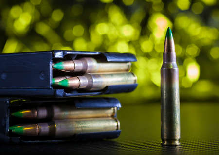 M855 military ammunition with metal magazines and yellow backgroundの写真素材