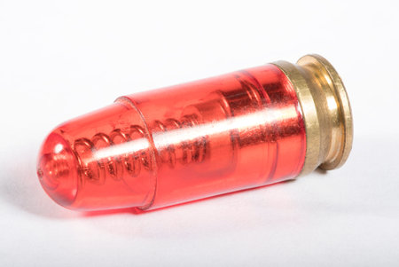 Inert cartridge for practicing handgun trigger control on whiteの写真素材