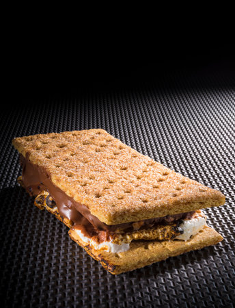 Smore just made on the fire on a black textured table