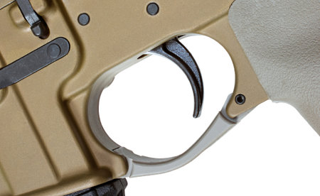Trigger on an AR-15 that is brown isolated on white