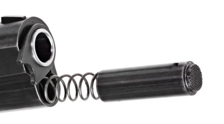 A 1911 handgun with spring coming out with its plug and barrel bushing