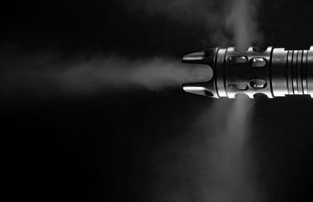 Muzzle of an AR-15 that has smoke flying out