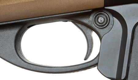 Trigger and safety on a shotgun with a gold colored receiver