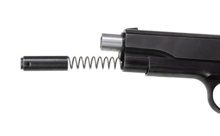 Spring and plunger coming out of a pistol to remove the slide
