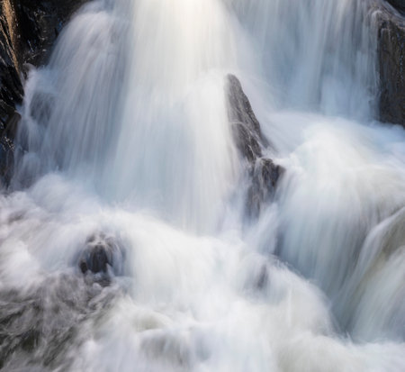 Cascade of water falling over boulders that is in Maineの写真素材
