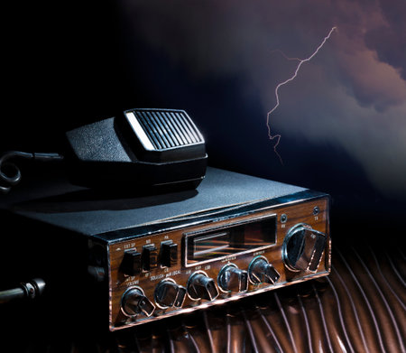 Lightning storm behind a ham radio and microphoneの写真素材