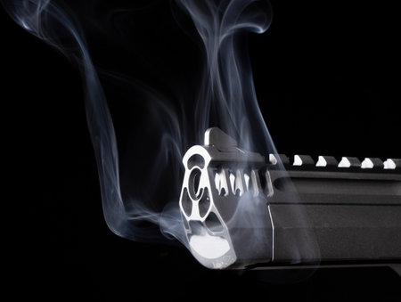Smoking barrel of a semi-automatic pistol on blackの写真素材