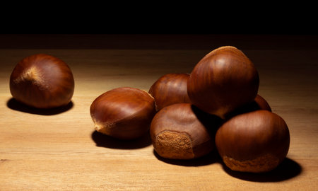 Batch of chestnuts on a table with a dark backgroundの写真素材