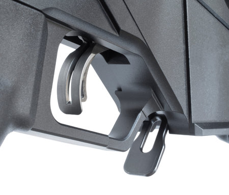 Double paddled trigger and magazine release on a modern rifle seen from a quartering angle from...