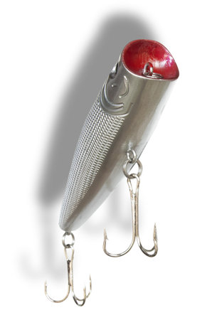 Shadow behind a silver colored artificial fishing bait with two treble hooks and silver in color...