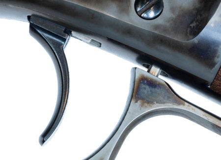 Smooth faced trigger on a lever action rifle with the lever secured and isolated on a white...