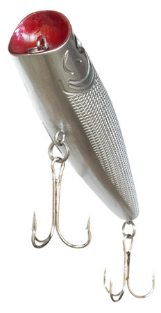 Silver colored artificial fishing bait with two treble hooks and silver in color seen from the bottom side as it rises toward the viewer.の写真素材
