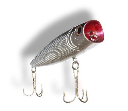 Silver colored topwater artificial fishing bait with a red face and two treble hooks and shadow behind.の写真素材